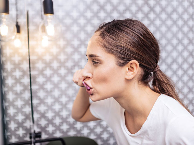 a woman brushing her teeth