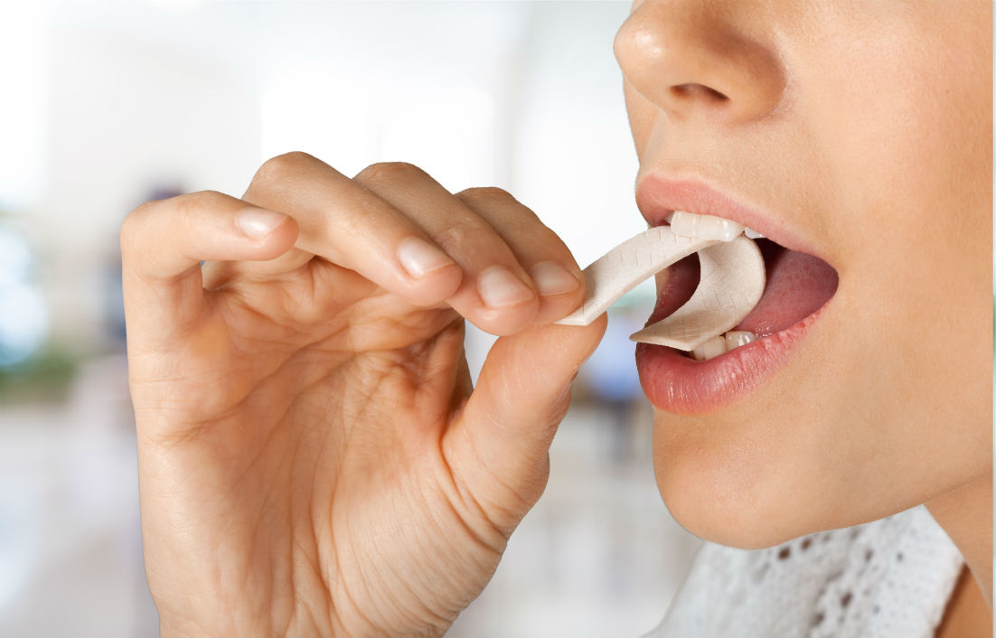 a close-up of a person eating a chewing gum 