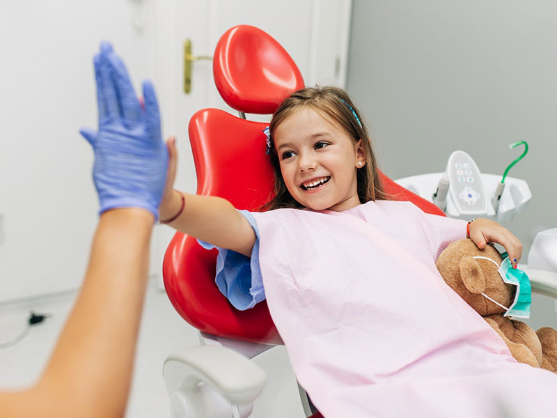 a girl giving high-five to doctor