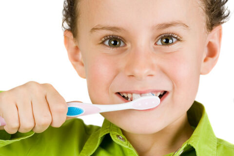 a boy brushing his teeth