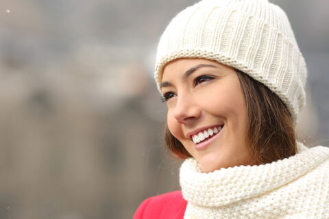 a woman in winter outfit smiling