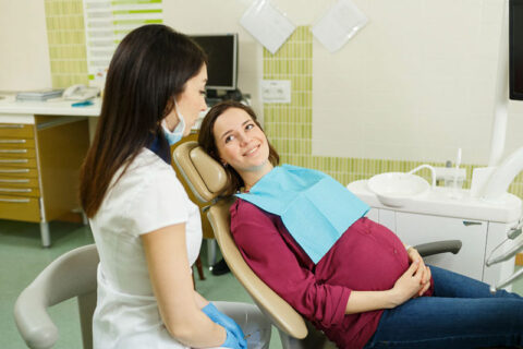 a doctor sitting in a chair with a pregnant person