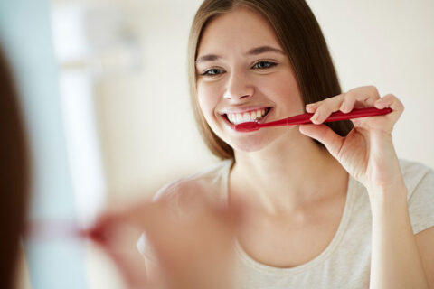 a girl brushing her teeth
