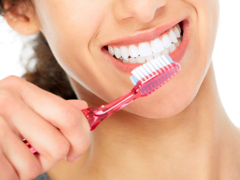 a woman brushing her teeth